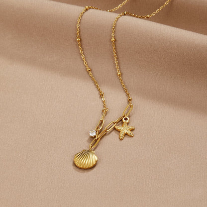 Goldene Halskette mit Muschel- und Seesternanhänger