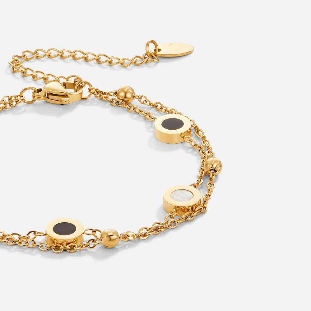 Armband mit Onyx- und Weißsteinanhängern in Gold
