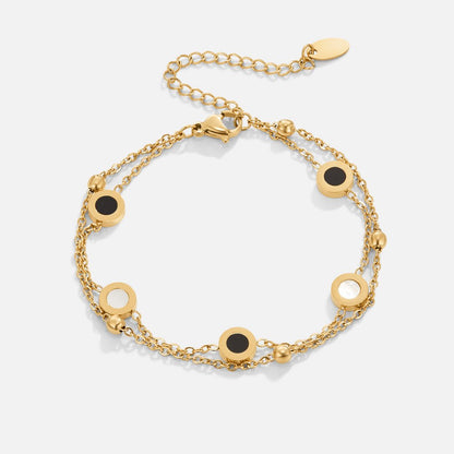 Armband mit Onyx- und Weißsteinanhängern in Gold